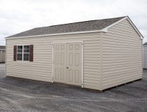 14x24 Peak Style Storage Shed with vinyl siding, a double door, four windows, and a loft built inside
