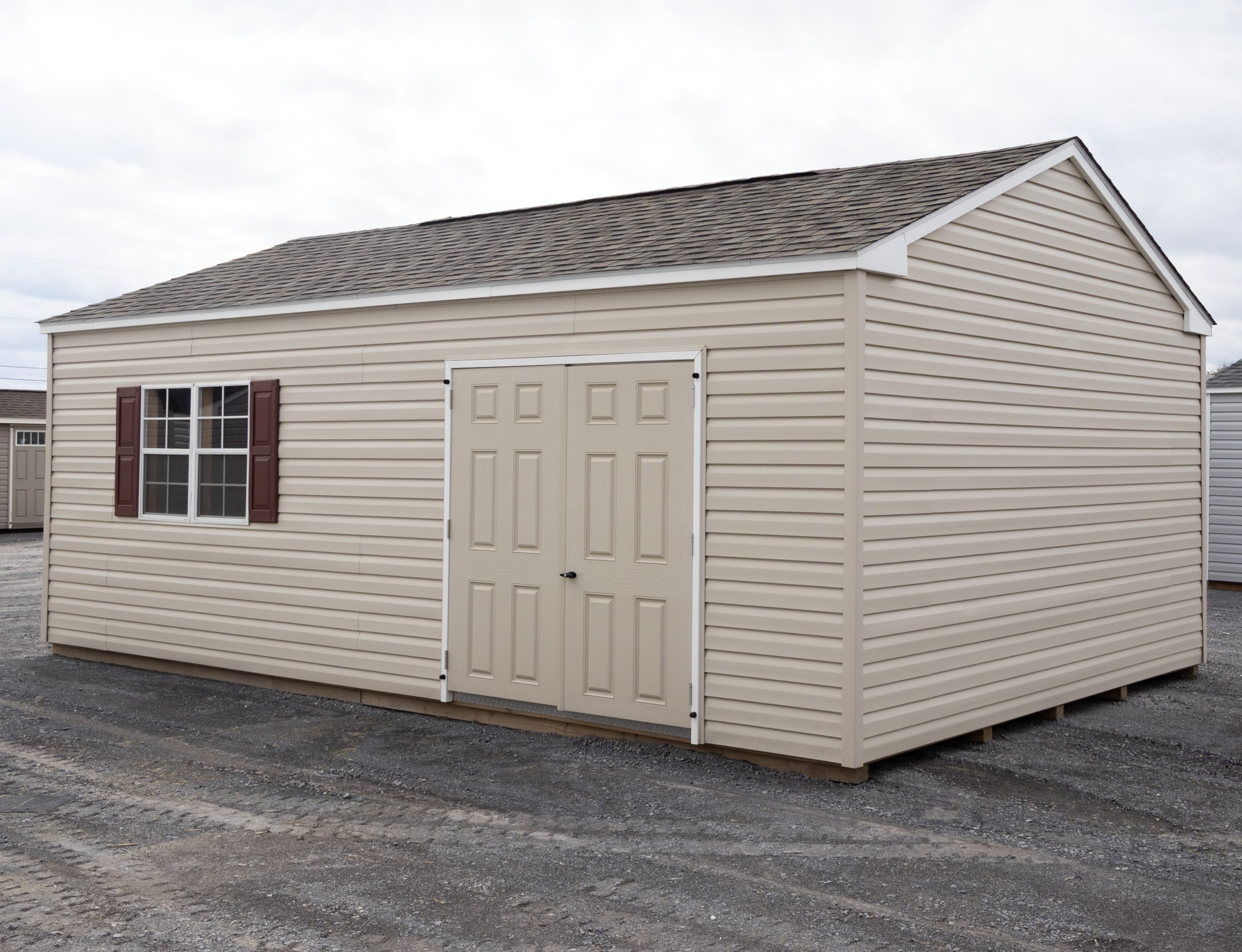 14x24 Peak Style Storage Shed with vinyl siding, a double door, four windows, and a loft built inside