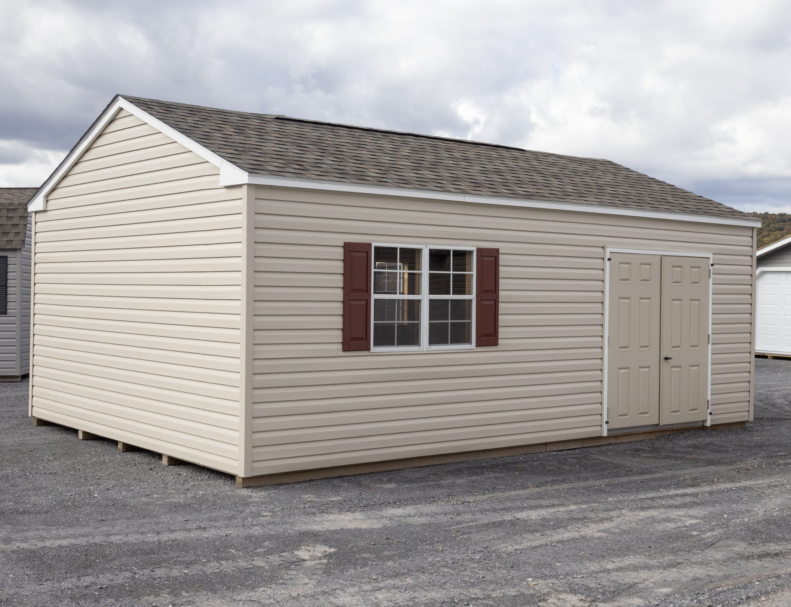 14x24 Peak Style Storage Shed with vinyl siding, a double door, four windows, and a loft built inside