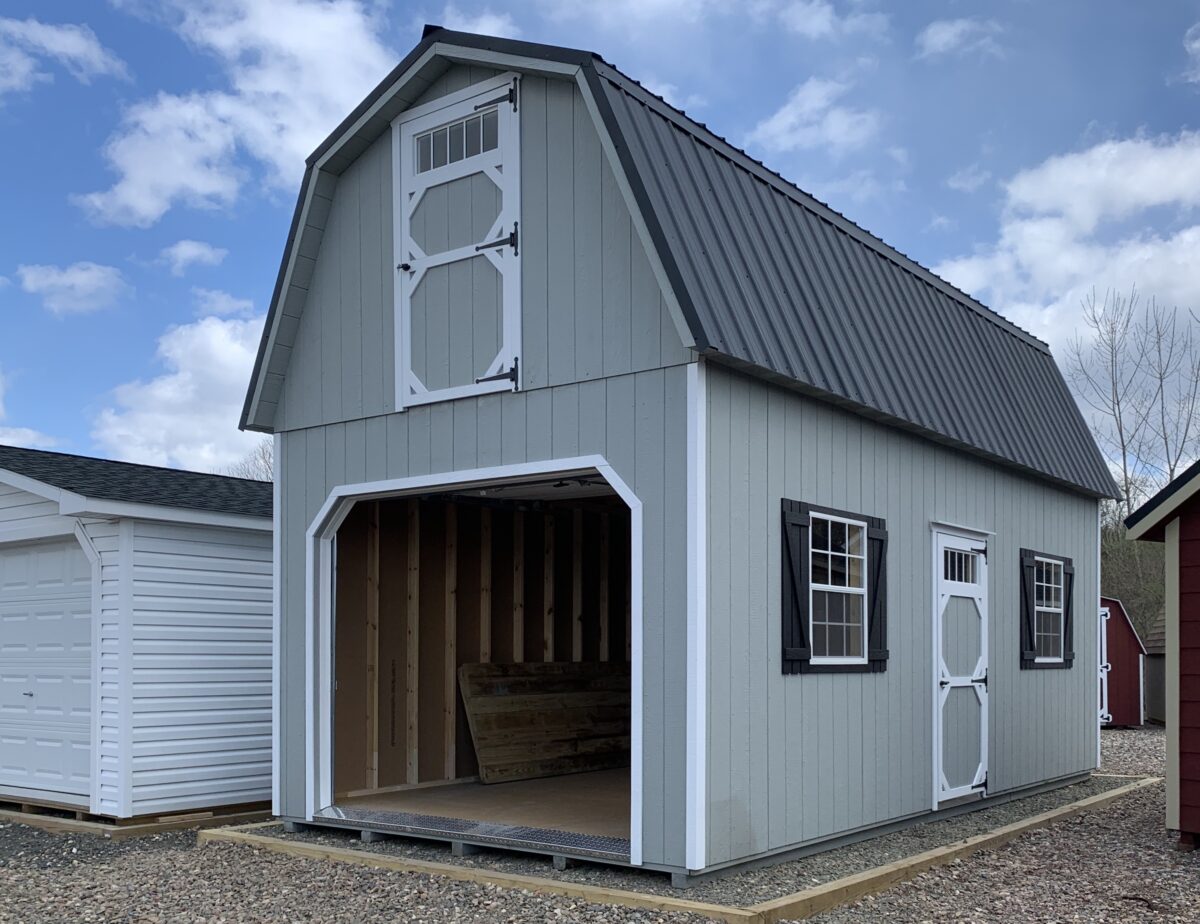 12x24 2 Story Garage in Light Grey with Black metal roof and 9x7 garage door.