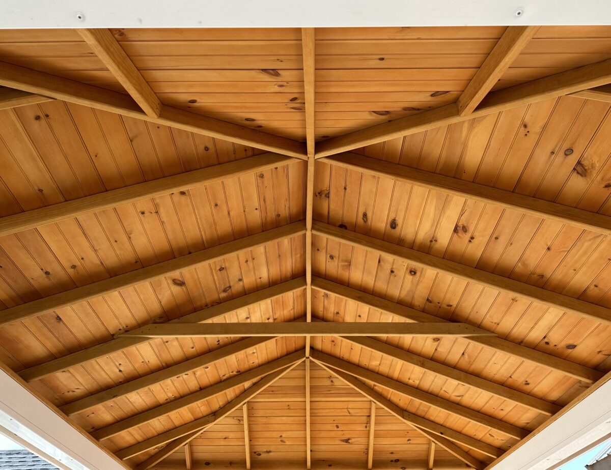 Interior view of a pavilion ceiling showing white pine tongue and groove pine and rafters.