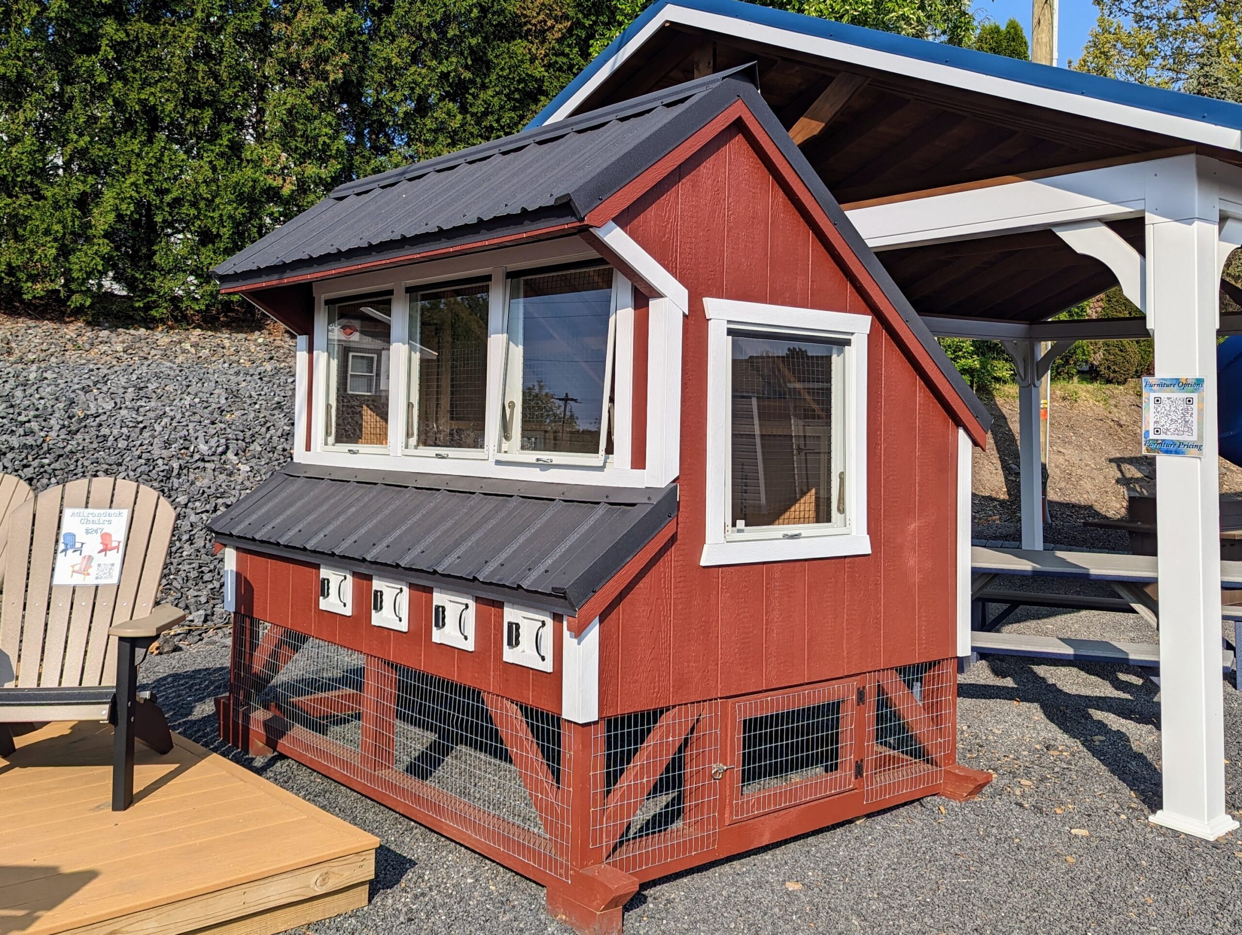 6x8 chicken coop in red LP SmartSide siding with white trim and black metal roof