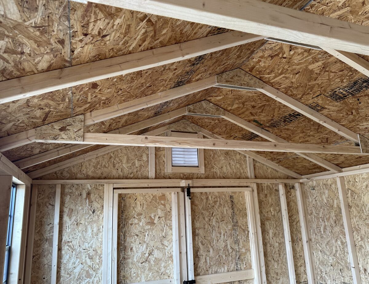 Close up of brown standing seam metal roof with double bubble insulation on a shed.