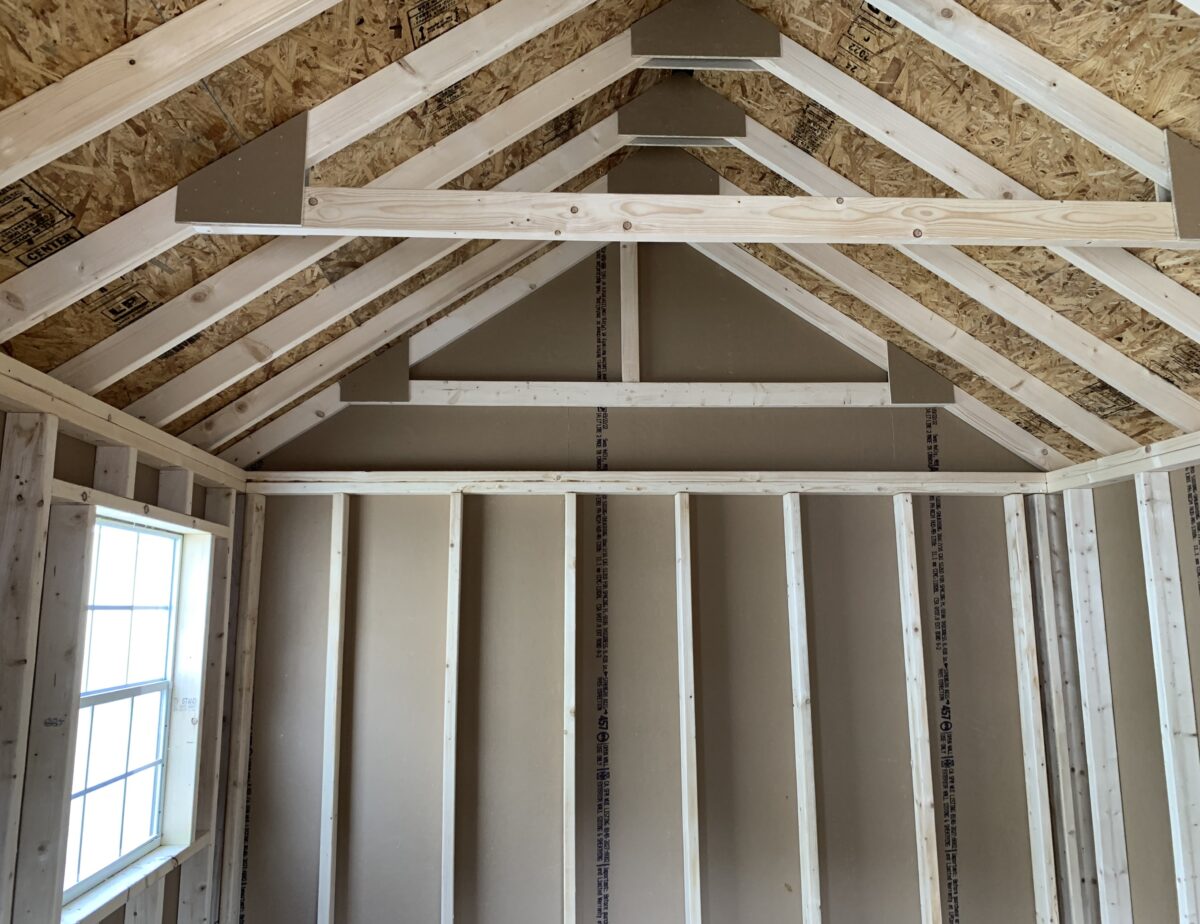 nterior wood framing of a 10x14 storage shed showing ridge vent and rafters