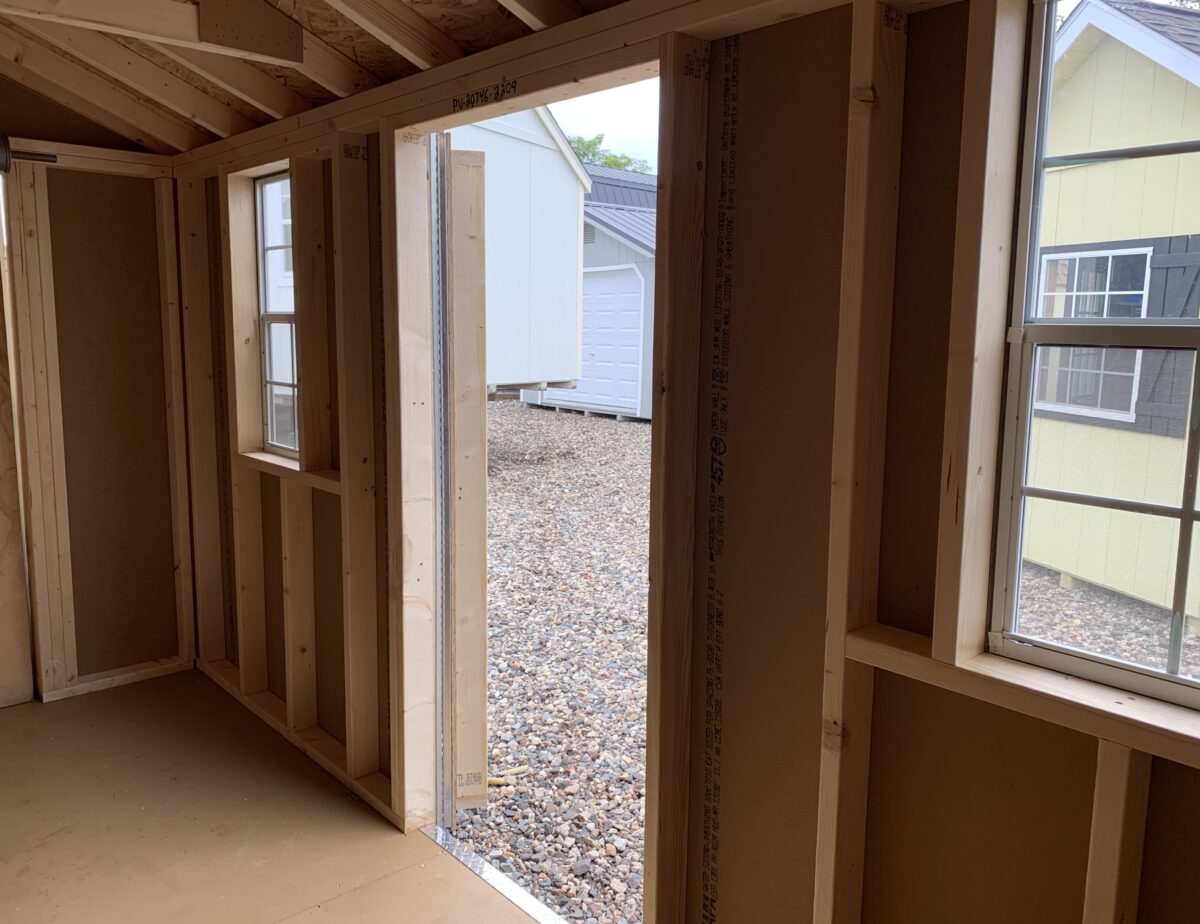 Interior of 10x14 storage shed showing wood framing and 25-year PerformMax floor