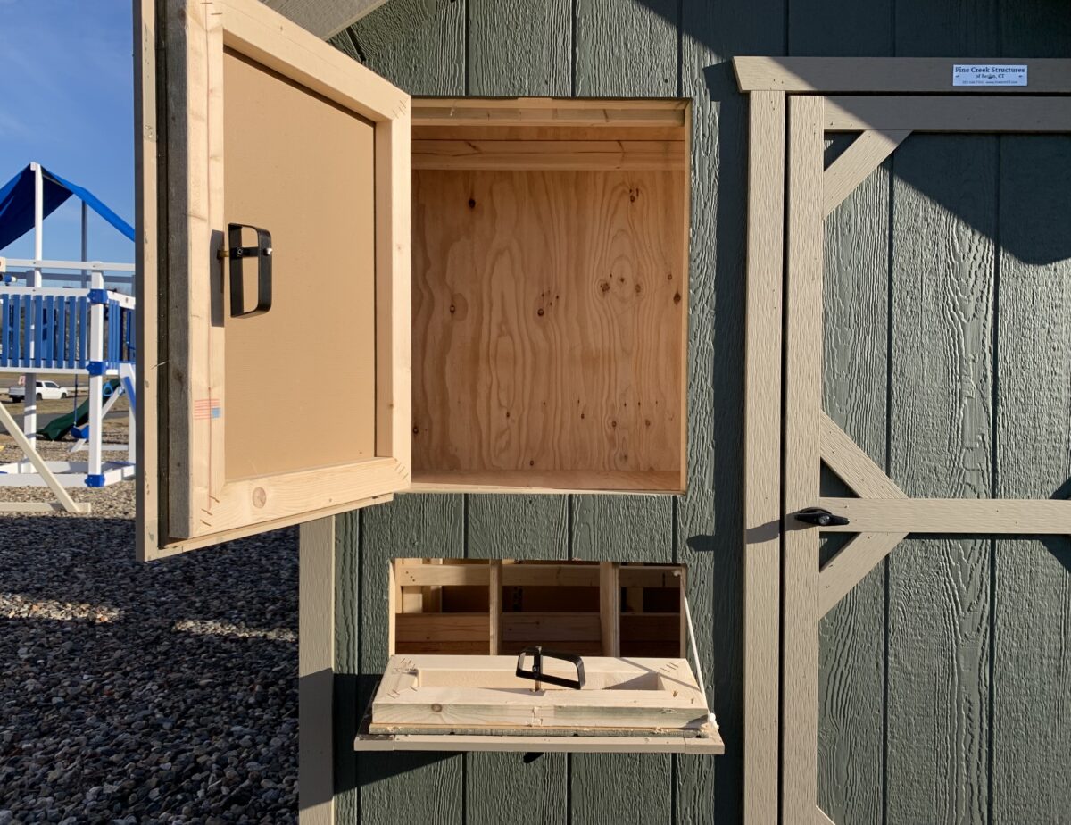 Interior of a 6x12 chicken coop showing 6-foot roosting bar and nesting box access.