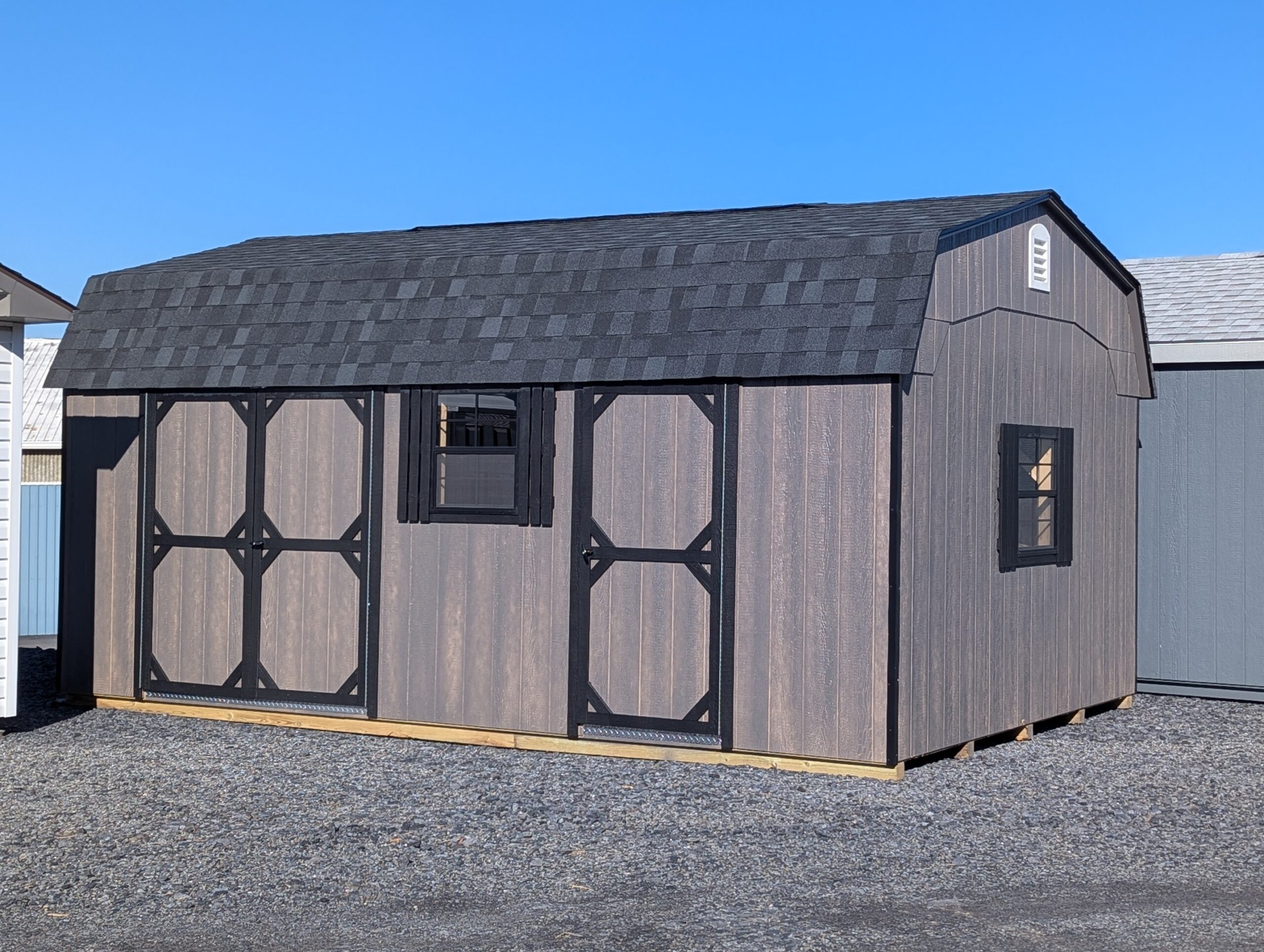 12x20 Dutch storage shed exterior in driftwood LP SmartSide siding with black trim and shingles