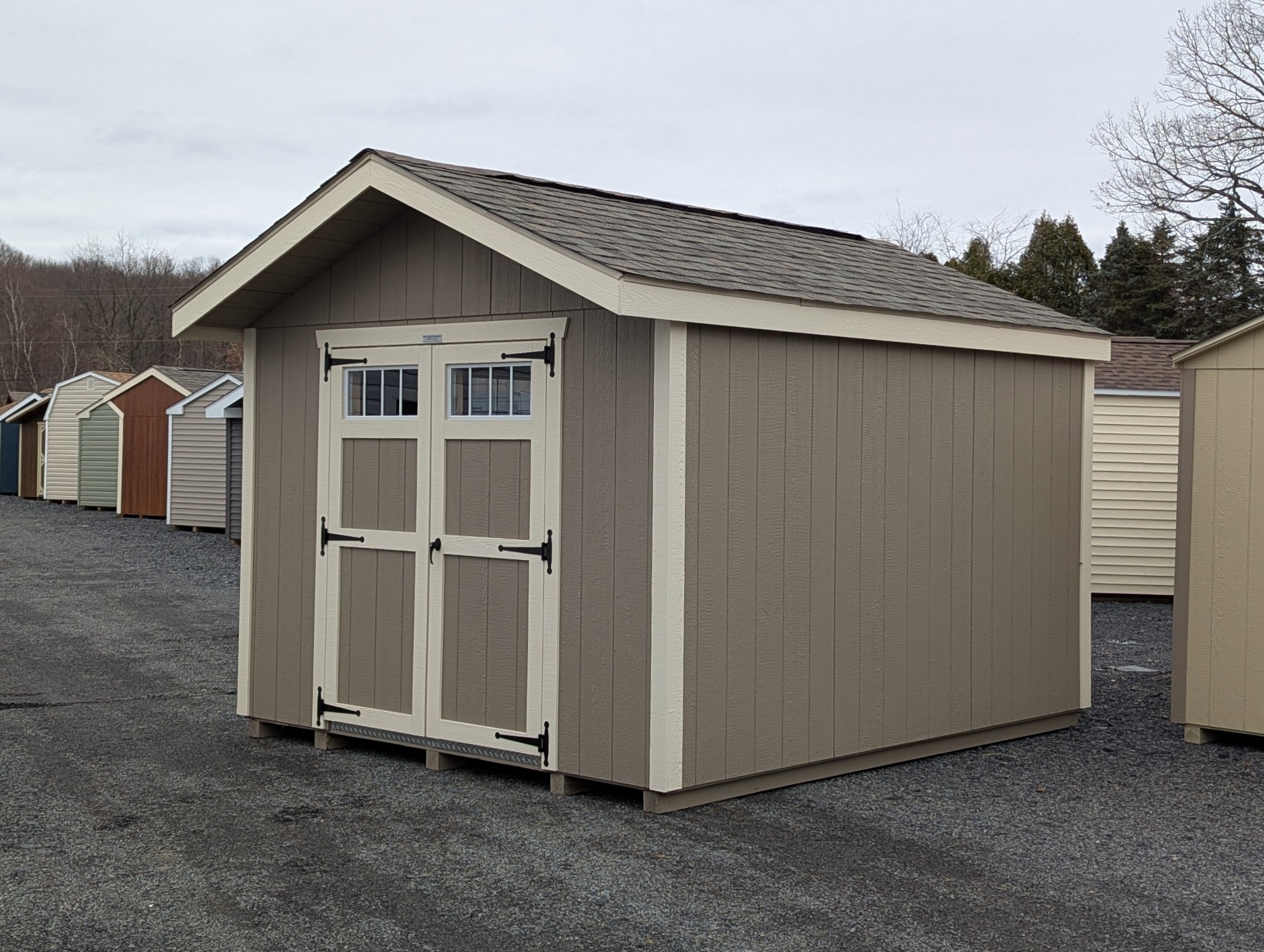 10x12 Peak Series shed in clay LP SmartSide siding with Navajo trim and transom windows in the 5' double doors
