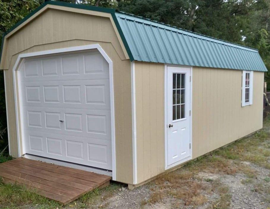 This is our high-quality Amish built 12x24 single car Dutch garage. It has a fiberglass door w/ windows, a 288 sq. ft. metal roof, diamond tread plate and a single entrance door on the side. (credit) plus a free ramp that comes with it. We also offer top to bottom warranty on this building as well as all our structures.