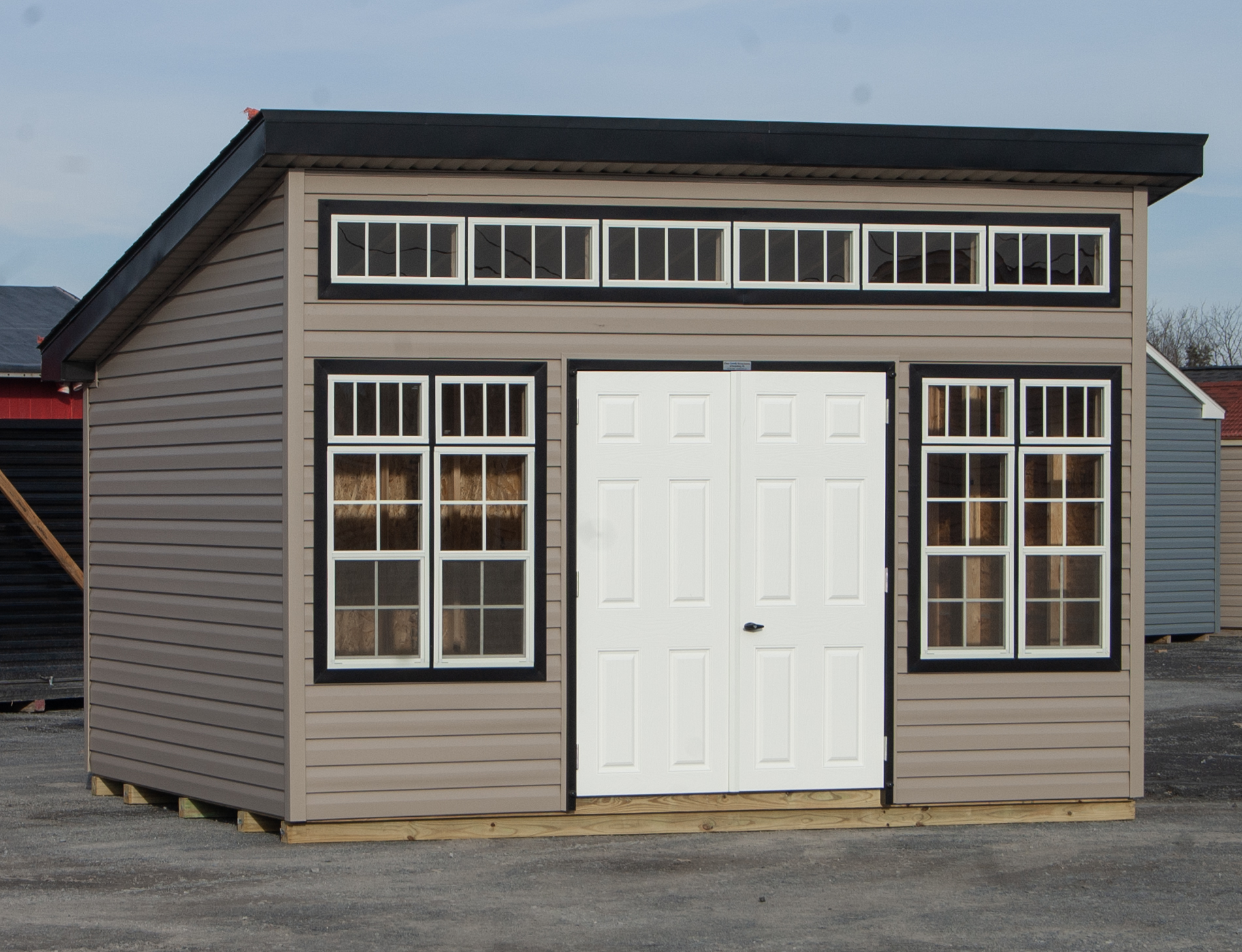 10x14 Studio Style Storage Shed with many windows and Pebble Clay vinyl siding