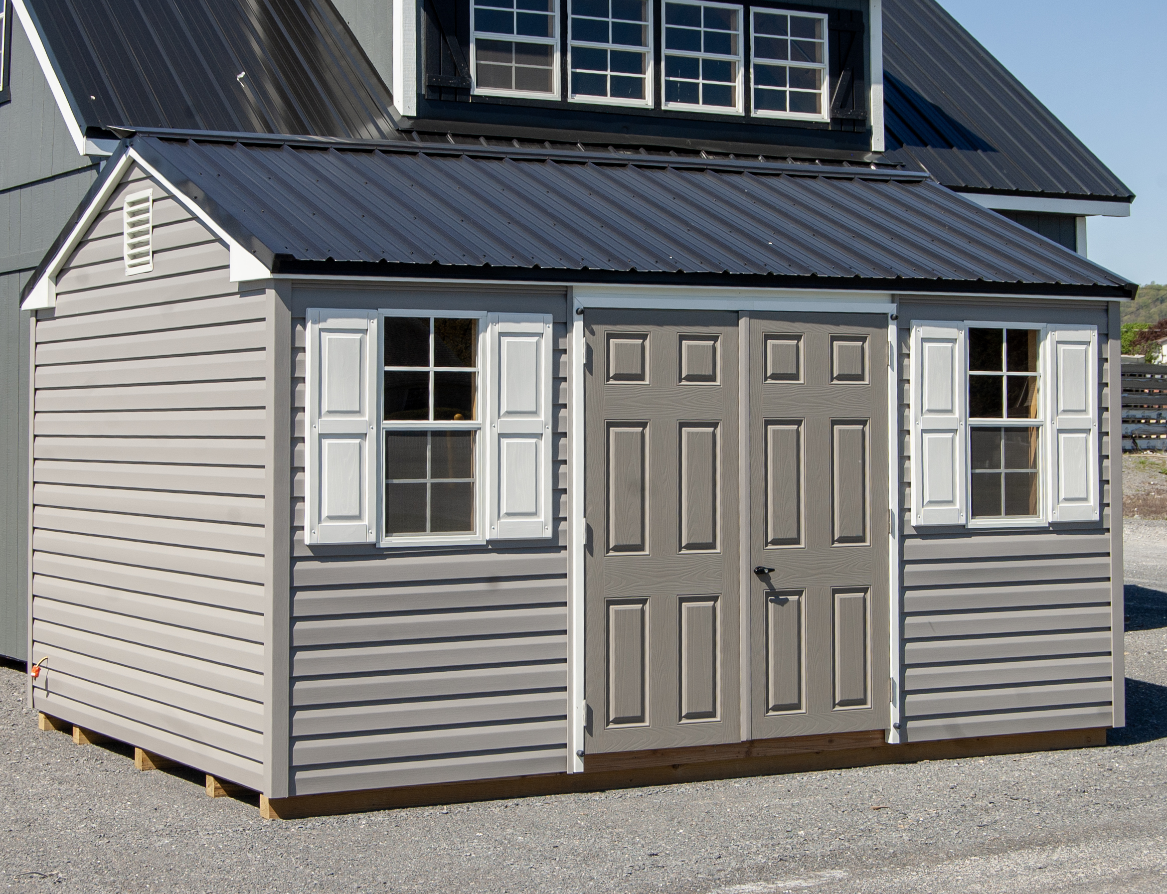 10x14 Peak Style Storage Shed with Gray Vinyl Siding, Black Metal Roof, Electric Package, and Built In Shelves