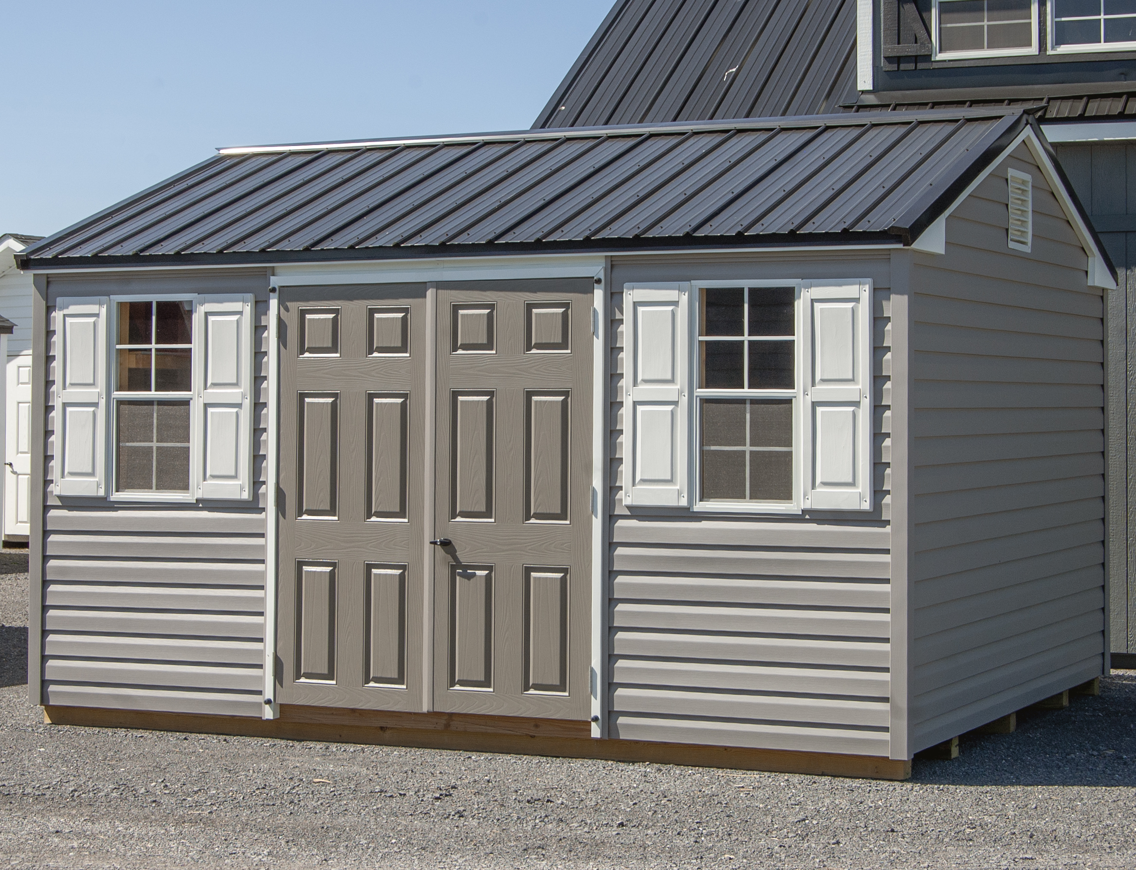 10x14 Peak Style Storage Shed with Gray Vinyl Siding, Black Metal Roof, Electric Package, and Built In Shelves