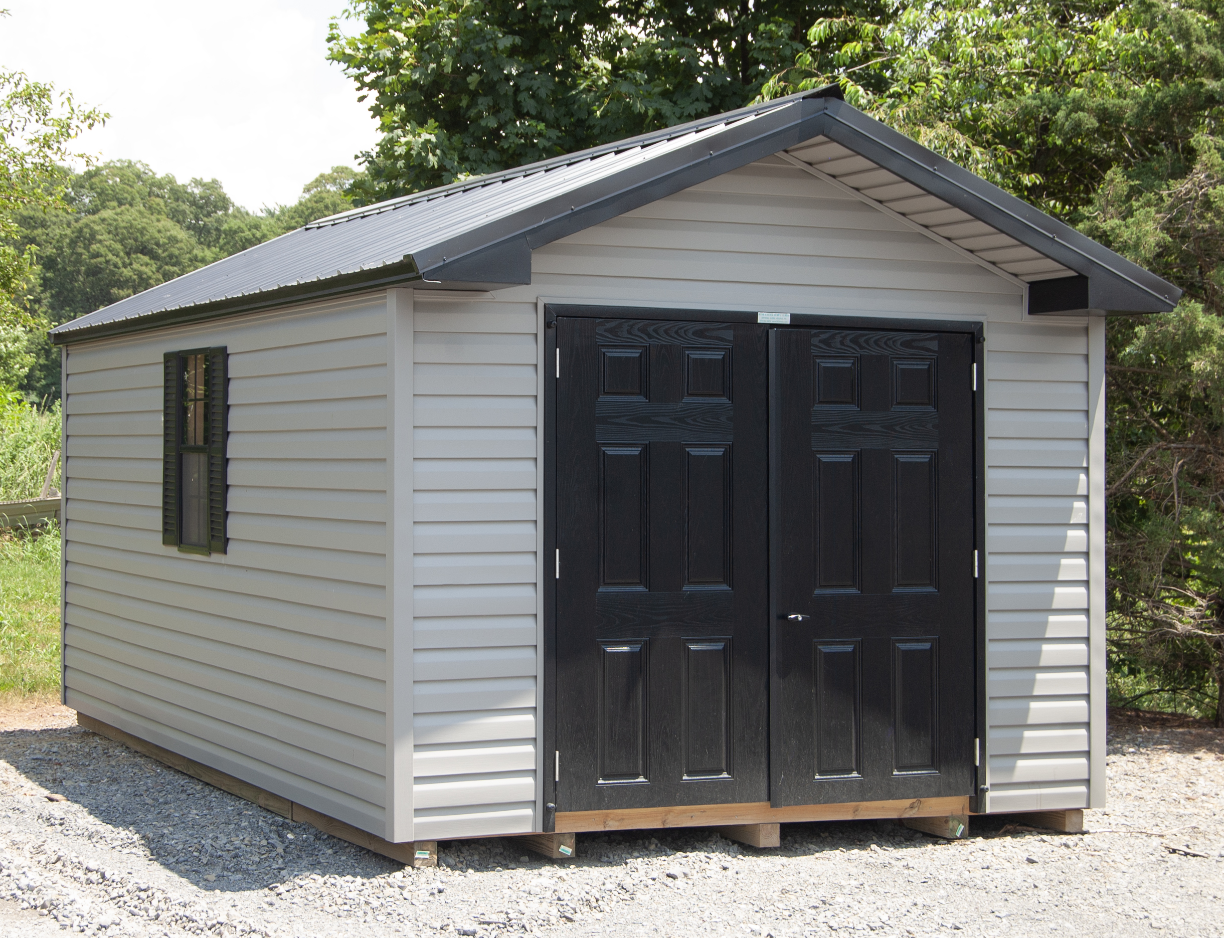 10×16 Front Entry Peak Storage Shed with grey vinyl siding, black fiberglass doors, and black metal roof