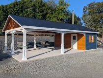 20x26 cabana with a metal roof, white vinyl posts, wooden siding, and two porch swings hanging in the open pavilion area.