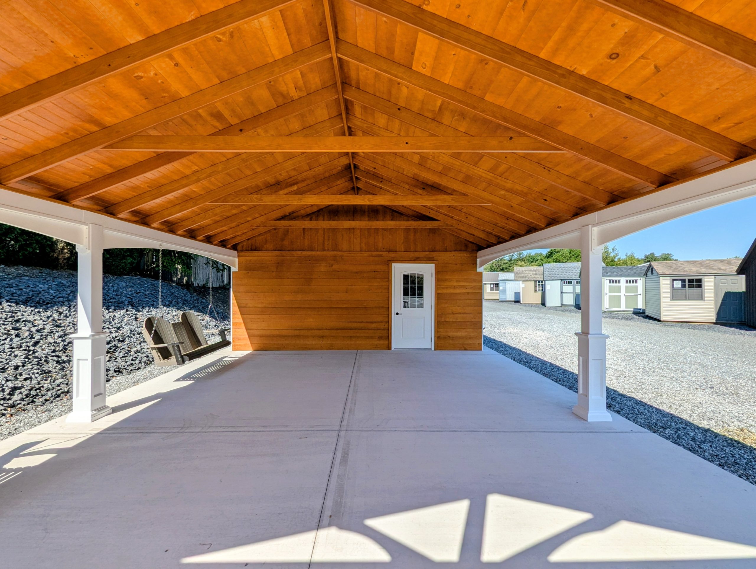 Interior view of the 20x26 cabana pavilion showing the vaulted wooden ceiling, white trim, and an enclosed room with a white door.