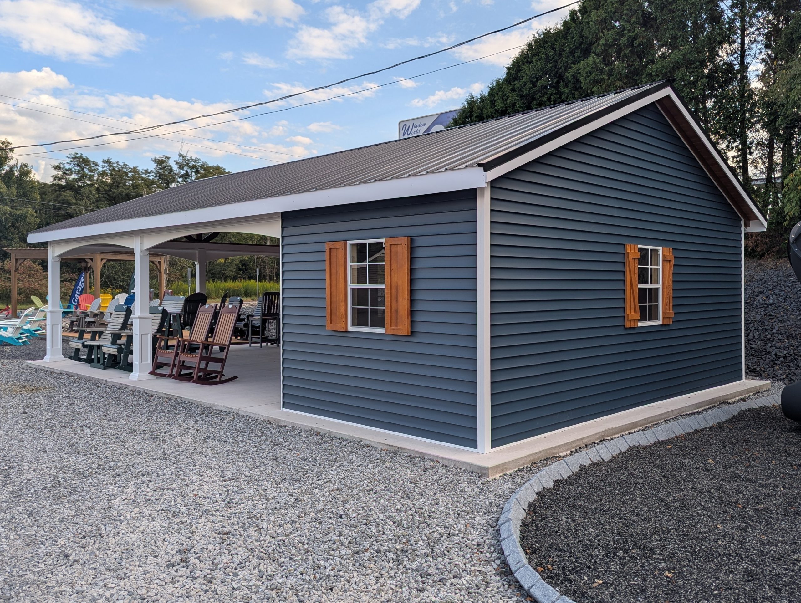 20x26 cabana with a metal roof, white vinyl posts, wooden siding, and two porch swings hanging in the open pavilion area.