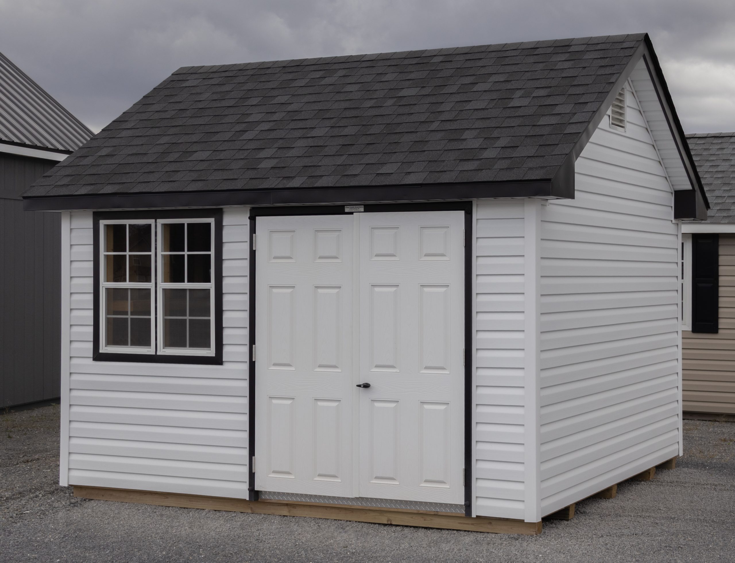 10x12 Premium Cape Cod Style Storage Shed with vinyl siding and custom shelf built inside