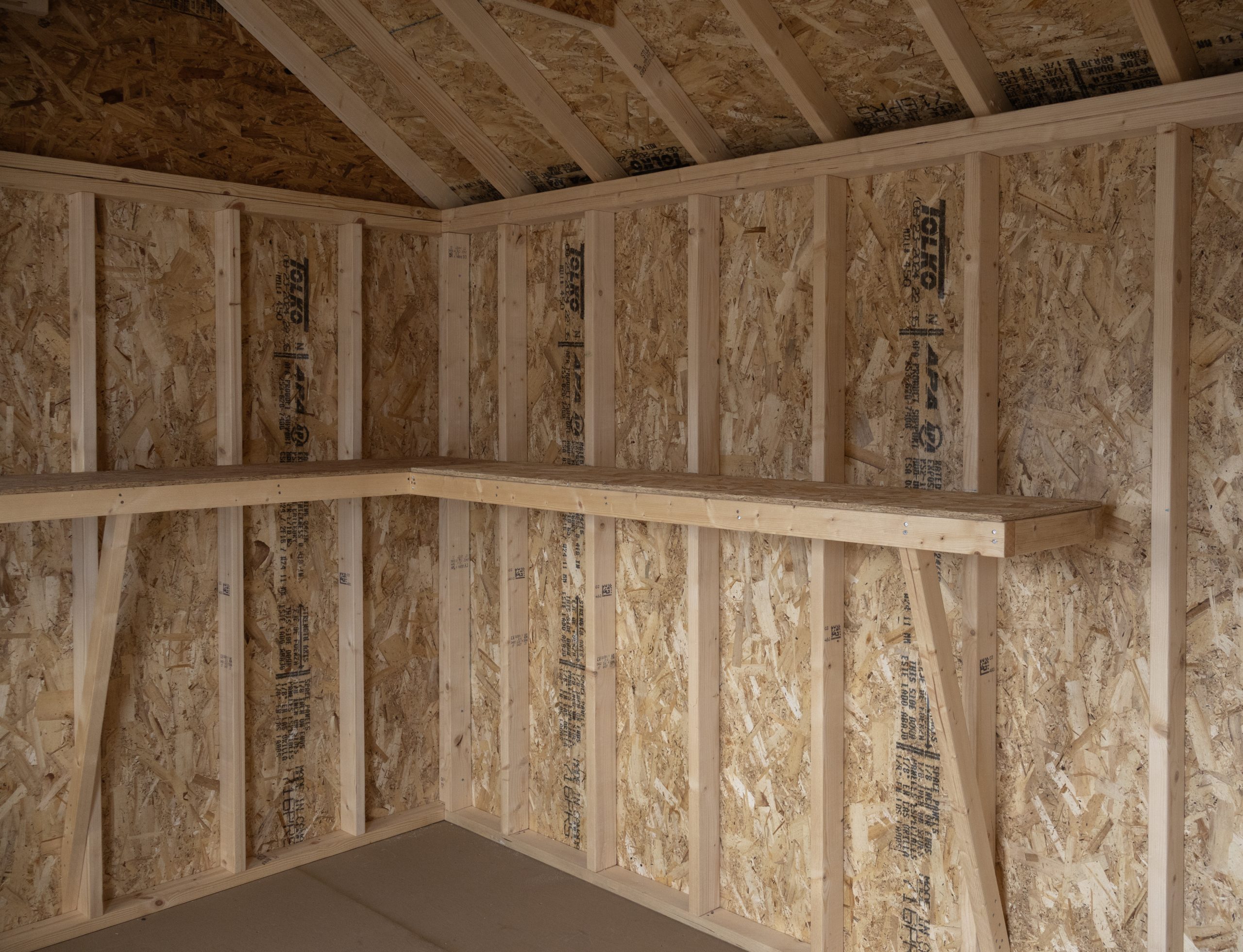 10x12 Premium Cape Cod Style Storage Shed with vinyl siding and custom shelf built inside