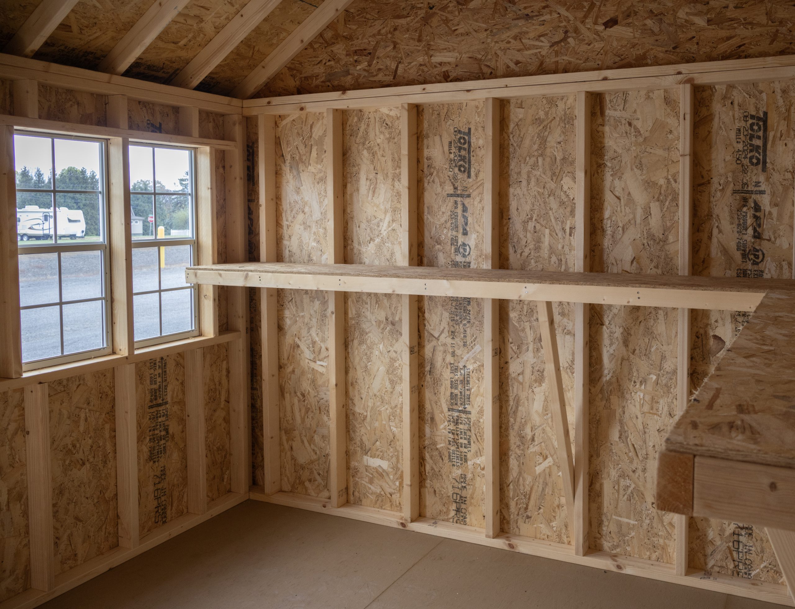 10x12 Premium Cape Cod Style Storage Shed with vinyl siding and custom shelf built inside