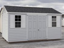 10x14 Peak Style Storage Shed with Harbor Stone Grey Vinyl Siding, a double door, and two single hung windows with shutters