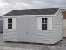 10x14 Peak Style Storage Shed with Harbor Stone Grey Vinyl Siding, a double door, and two single hung windows with shutters