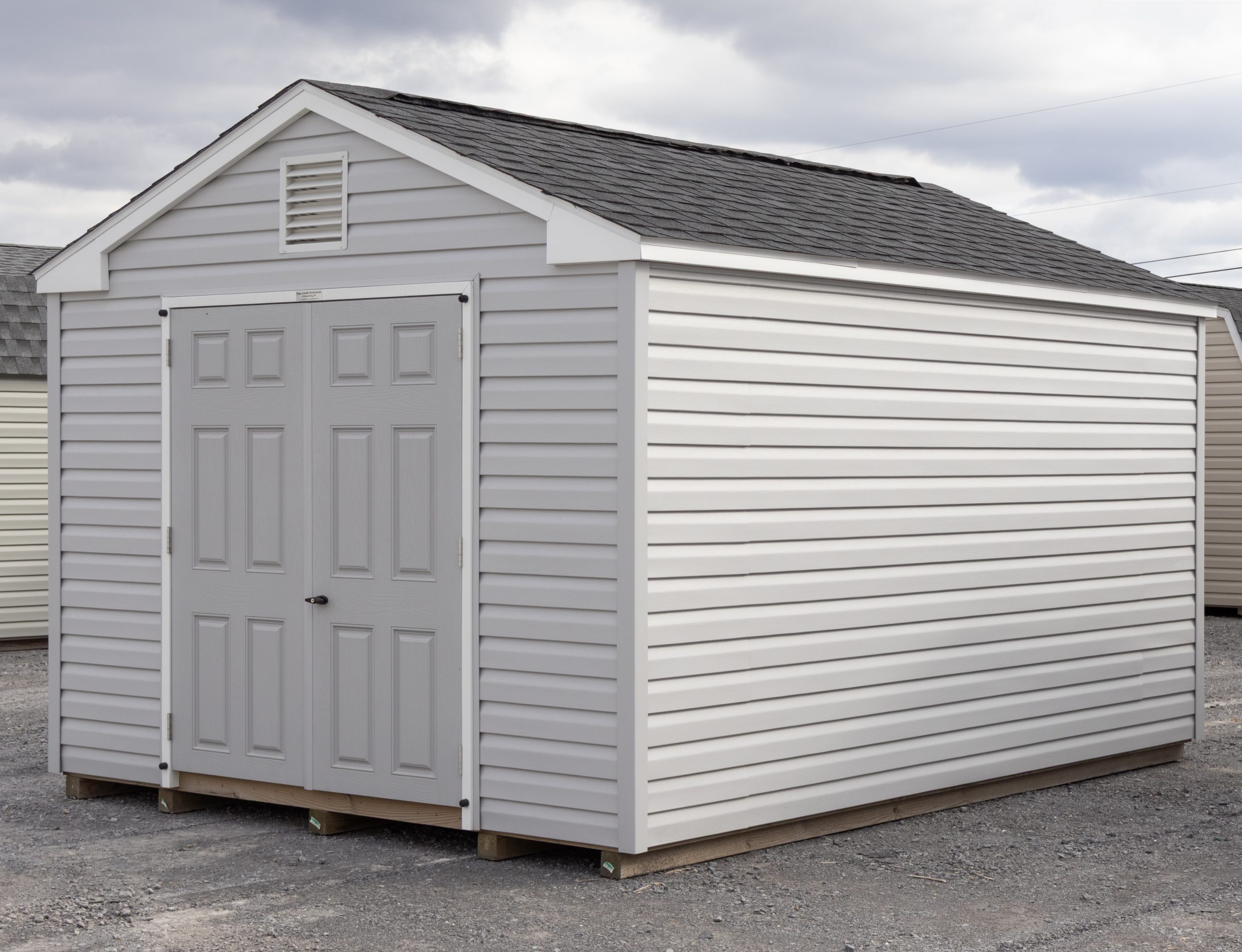 10x14 Peak Style Storage Shed With Vinyl Siding, Double Door in front, and window in back