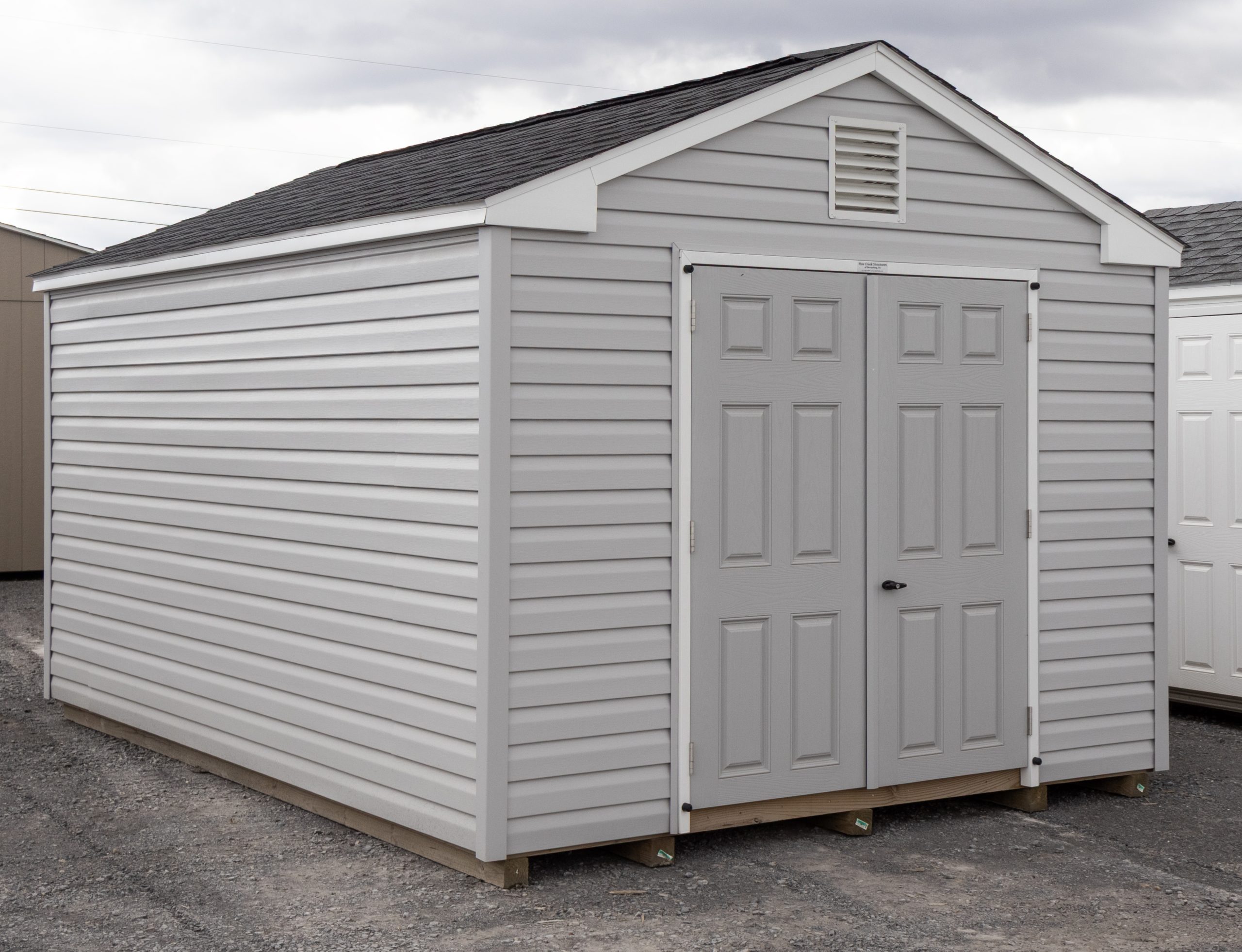 10x14 Peak Style Storage Shed With Vinyl Siding, Double Door in front, and window in back