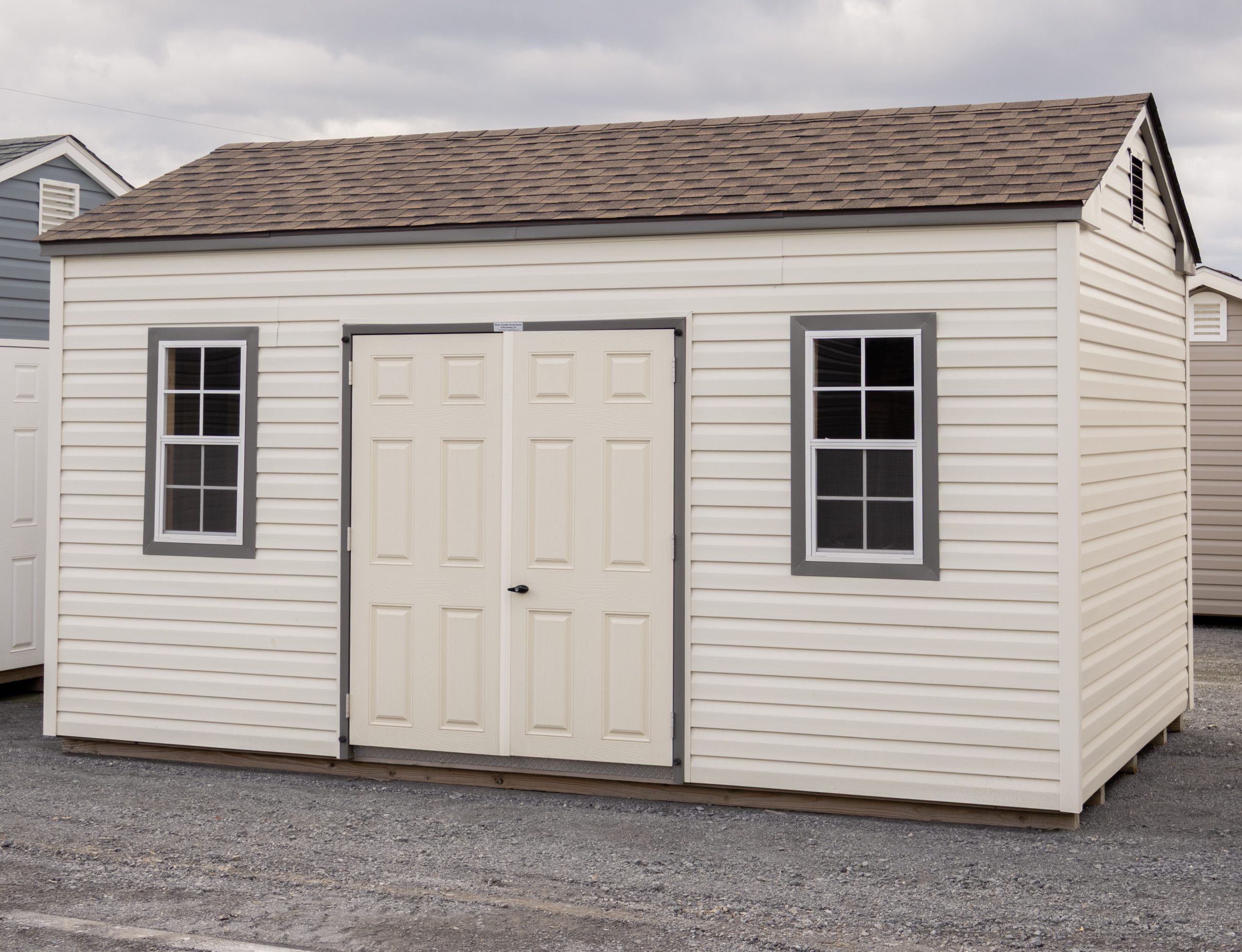 10x16 Peak Storage Shed with Classic Sand Vinyl Siding, Double Door and Two windows with trim