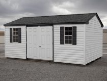 10x18 Peak Style Storage Shed with white vinyl siding and black accents