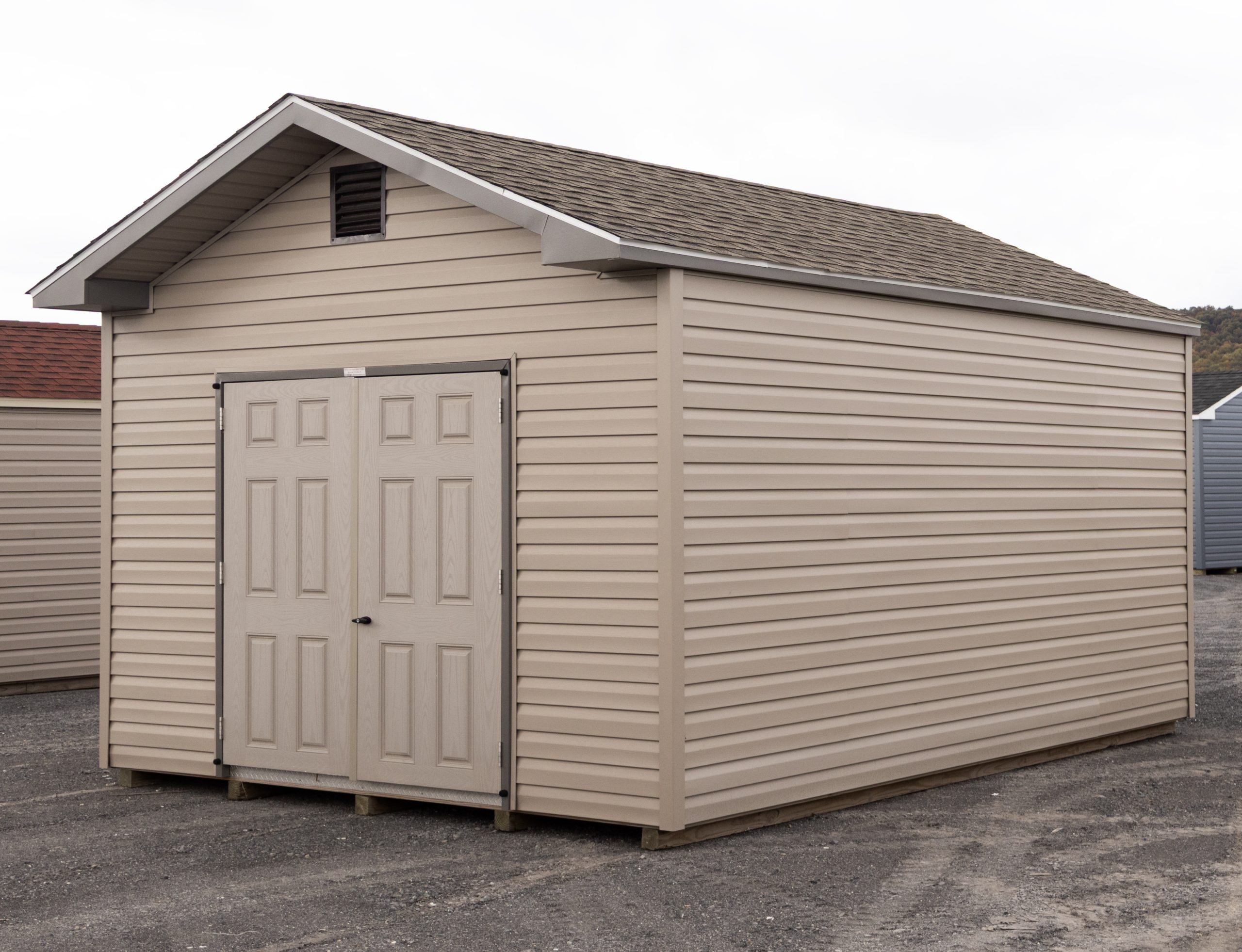 12x16 Front Entry Peak Shed with Vinyl Siding, double doors, a window in the back, and gable end vents