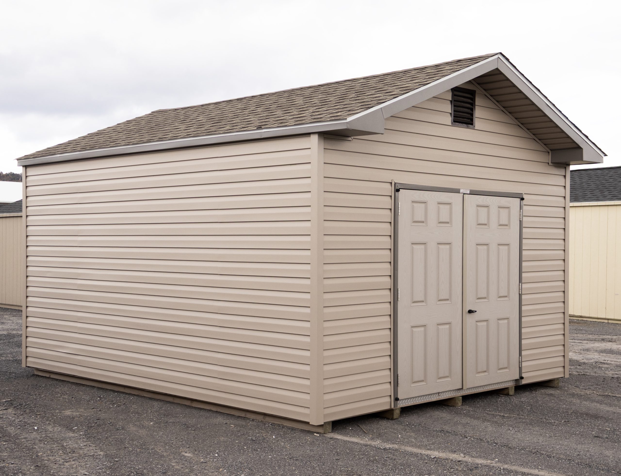 12x16 Front Entry Peak Shed with Vinyl Siding, double doors, a window in the back, and gable end vents