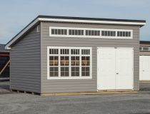 12x16 Studio Style Storage Shed with many windows and graphite grey vinyl siding