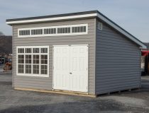 12x16 Studio Style Storage Shed with many windows and graphite grey vinyl siding
