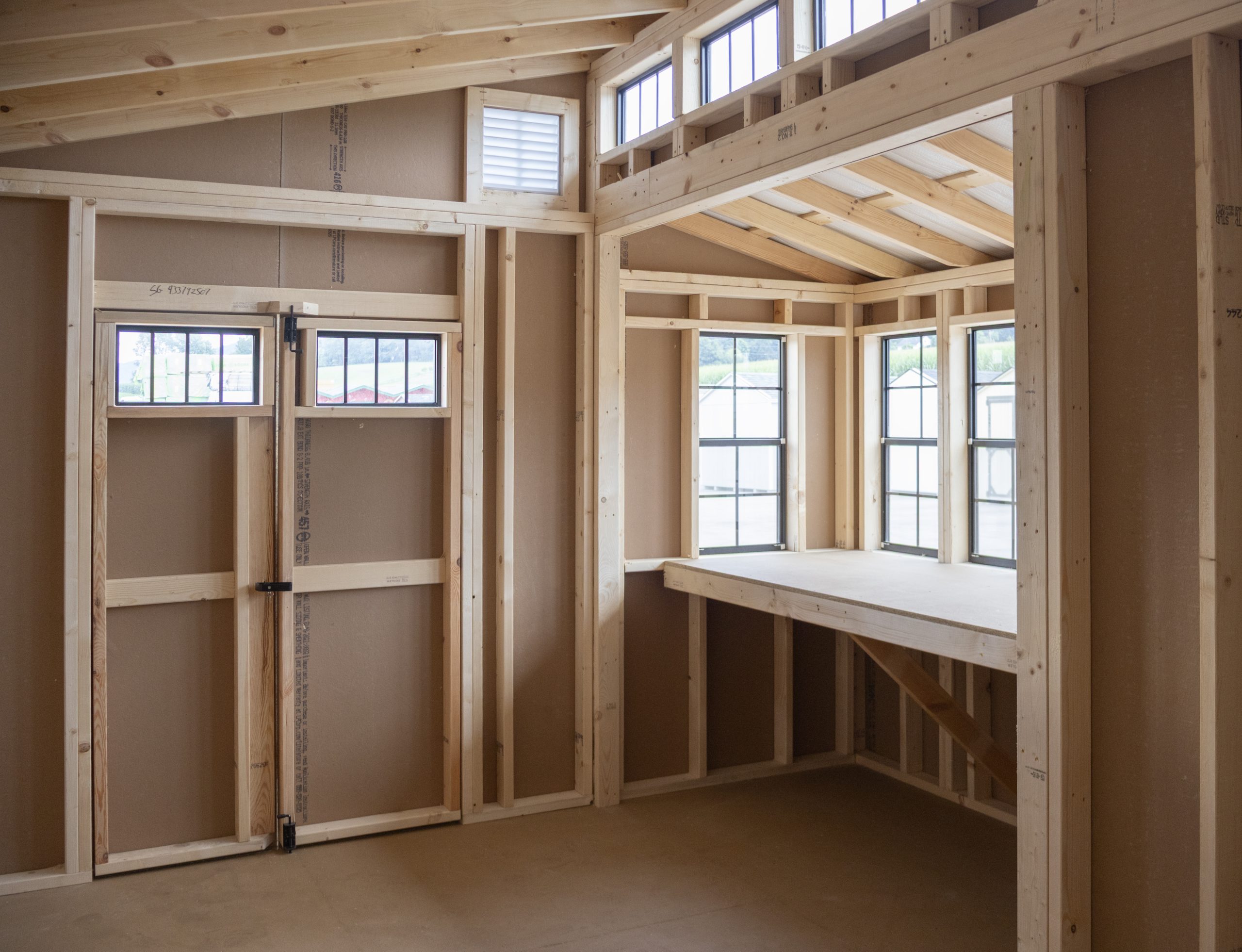 12x16 Custom Studio Style Storage Shed With Hemlock Porch and Workbench inside