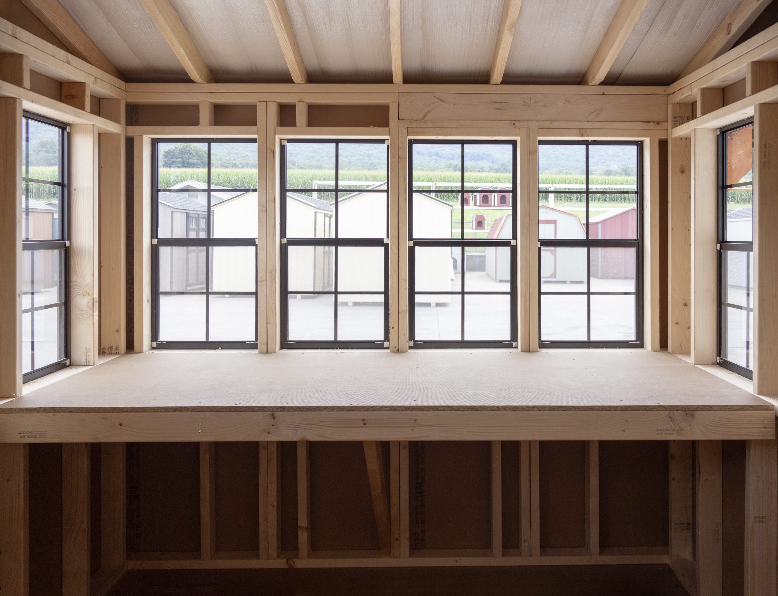 12x16 Custom Studio Style Storage Shed With Hemlock Porch and Workbench inside