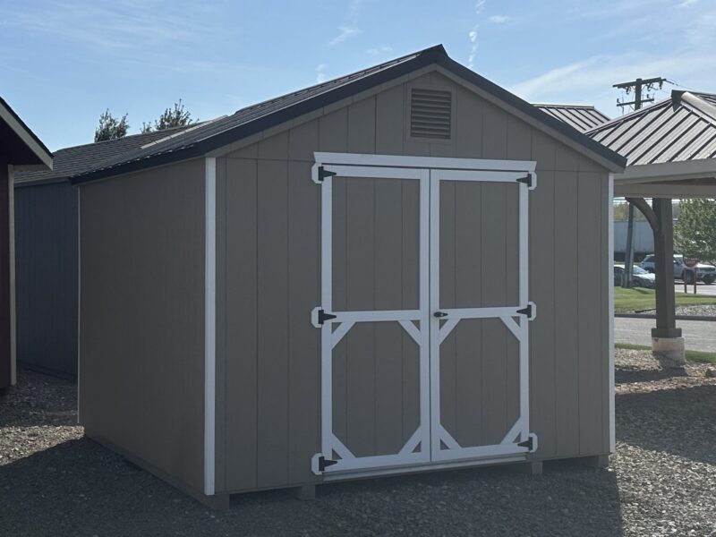 Front exterior view of a 10x10 Madison Peak storage shed featuring a PC clay finish, white trim, black shutters, and wide double doors.