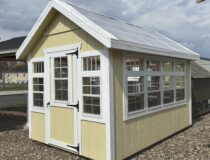 Cream colored 8x12 Atrium Greenhouse with white trim and polycarbonate roof in Berlin, CT.