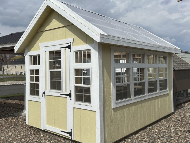 Cream colored 8x12 Atrium Greenhouse with white trim and polycarbonate roof in Berlin, CT.