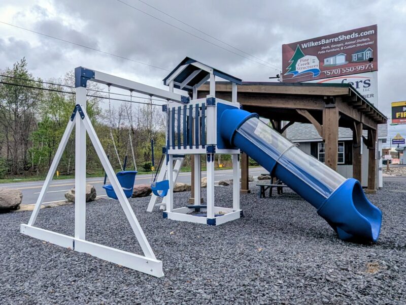 Vinyl-sleeved pressure treated wood playset with tube slide, clubhouse, and bucket swings on gravel lot