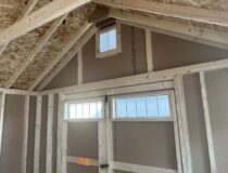 3x6 single entry door with transom windows and two 24x36 windows with black shutters.