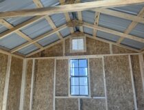 Interior framing view of a Pine Creek Structures shed roof structure showing sturdy wooden rafters and ridge beam construction.
