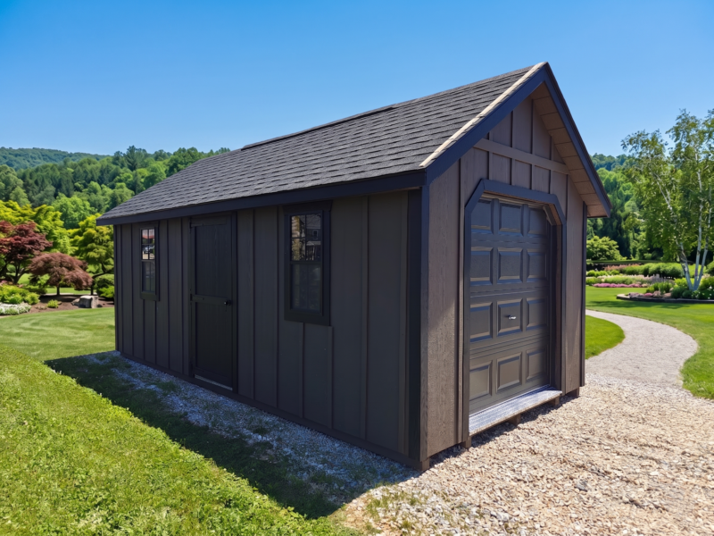 Exterior view of a bronze 10x20 Cape Cod storage shed with black trim, a closed overhead garage door, and a diamond treadplate entry sill.