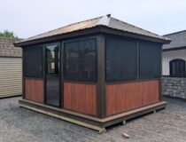 12x14 three season screened cabana with cedar-tone panels, aluminum roof, and sliding screen door