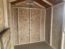 Interior roof rafters and clean wall studs of a 6x10 wood shed
