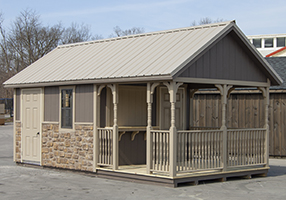 Custom Cape Cod Style Storage Shed with Concession Window, Counter, Porch, Railing, Stonework, and Metal Roof