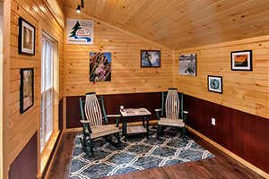 Custom Home Office Building from Pine Creek Structures | Finished Shed Interior with knotty pine walls, LP wainscot, electrical package, and custom upgrades