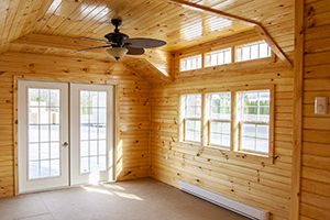 Custom Home Office Building from Pine Creek Structures | Finished Shed Interior with knotty pine walls, heat, fan, and custom upgrades
