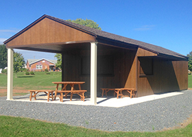 Custom Concession Stand Style Building with porch, concession windows, overhangs, and storage area
