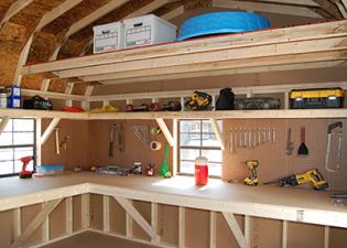 Storing a items in a shed with a loft, shelves, a workbench, and pegboard